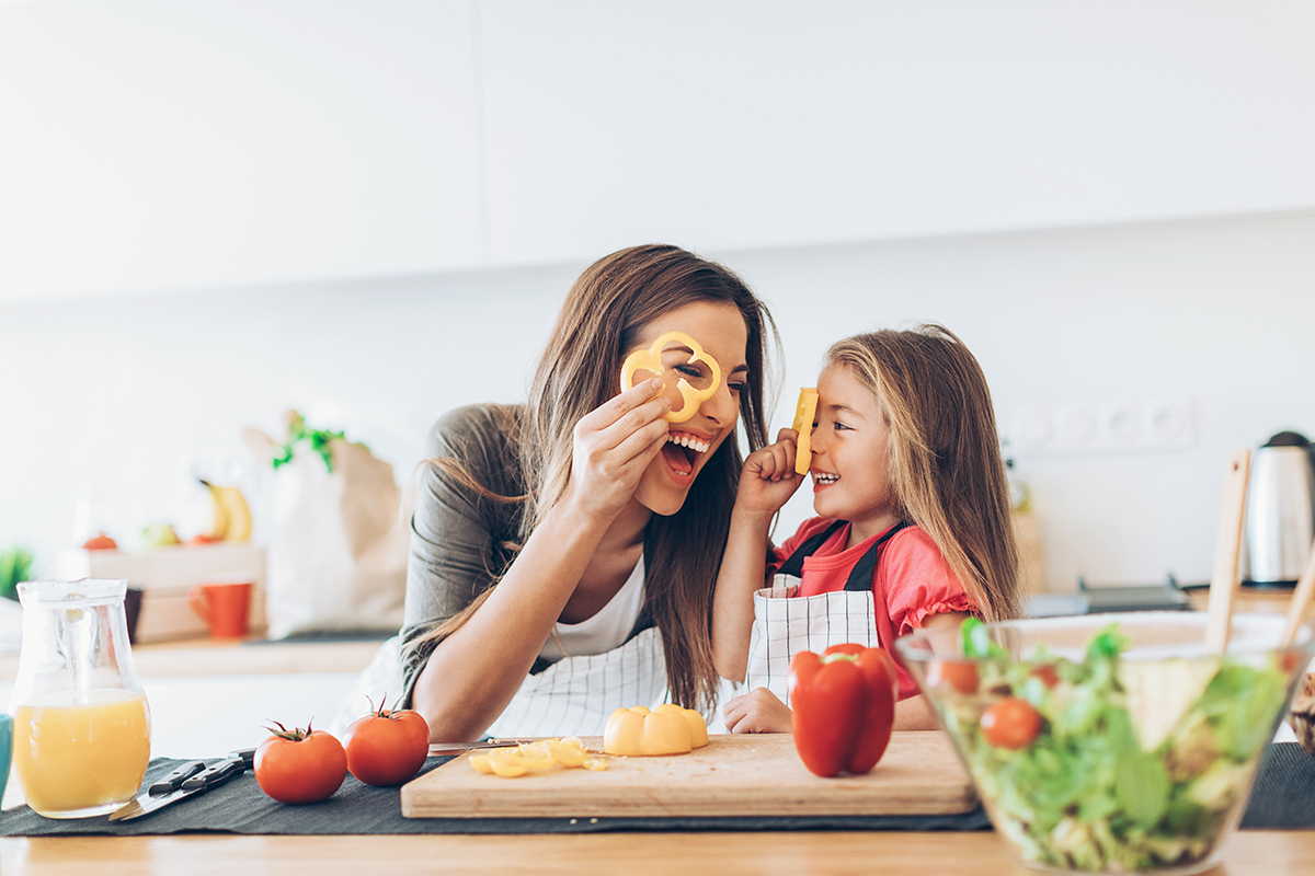Little girl cooking with mom in the kitchen