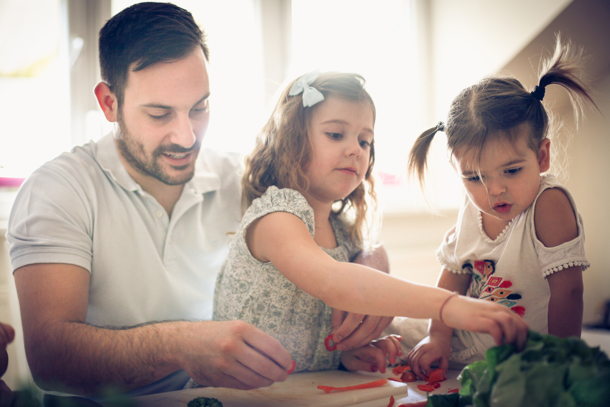 Dad and girls cooking together